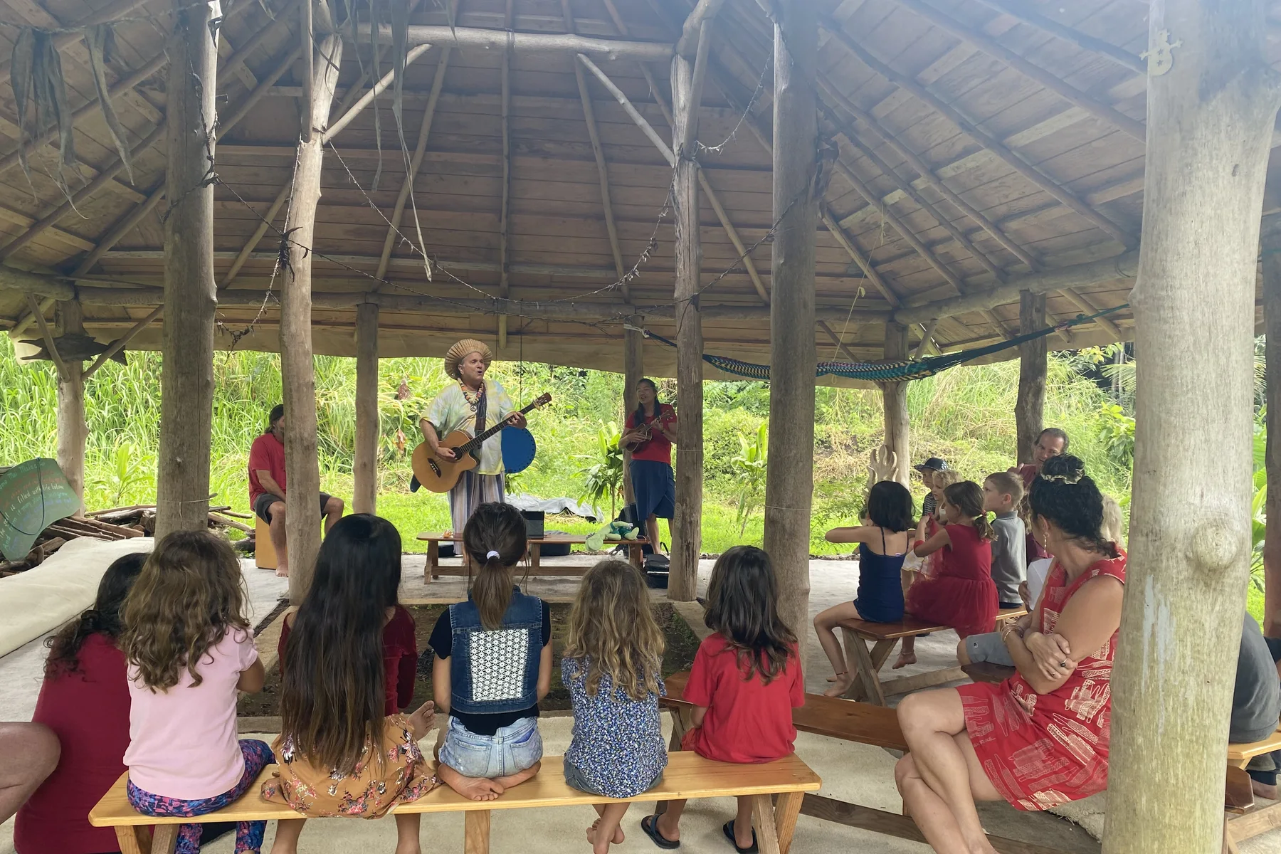 Neighbors gathering for music and conversation in a covered community place