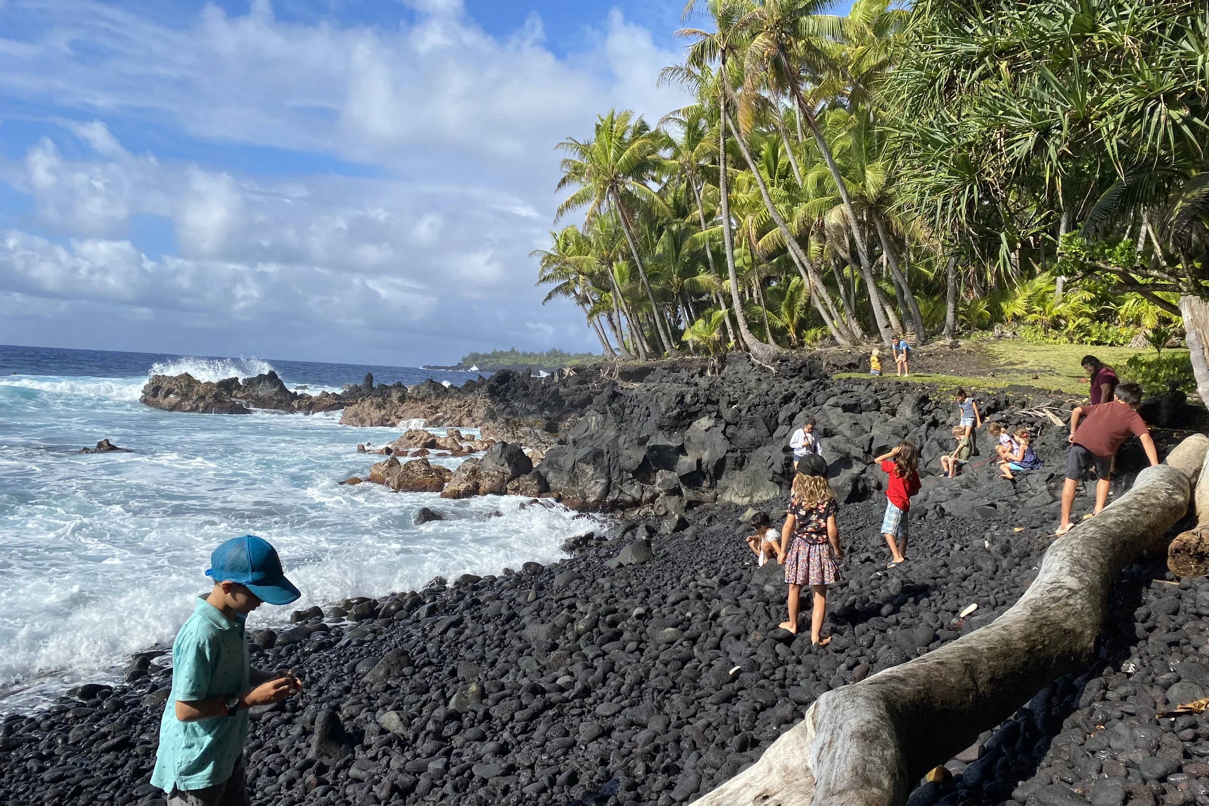 Families exploring the rocky Red Road coastline