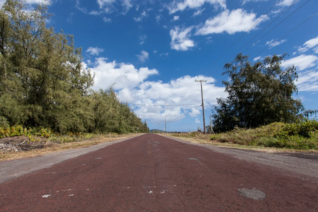 Red Road beneath a bright island sky